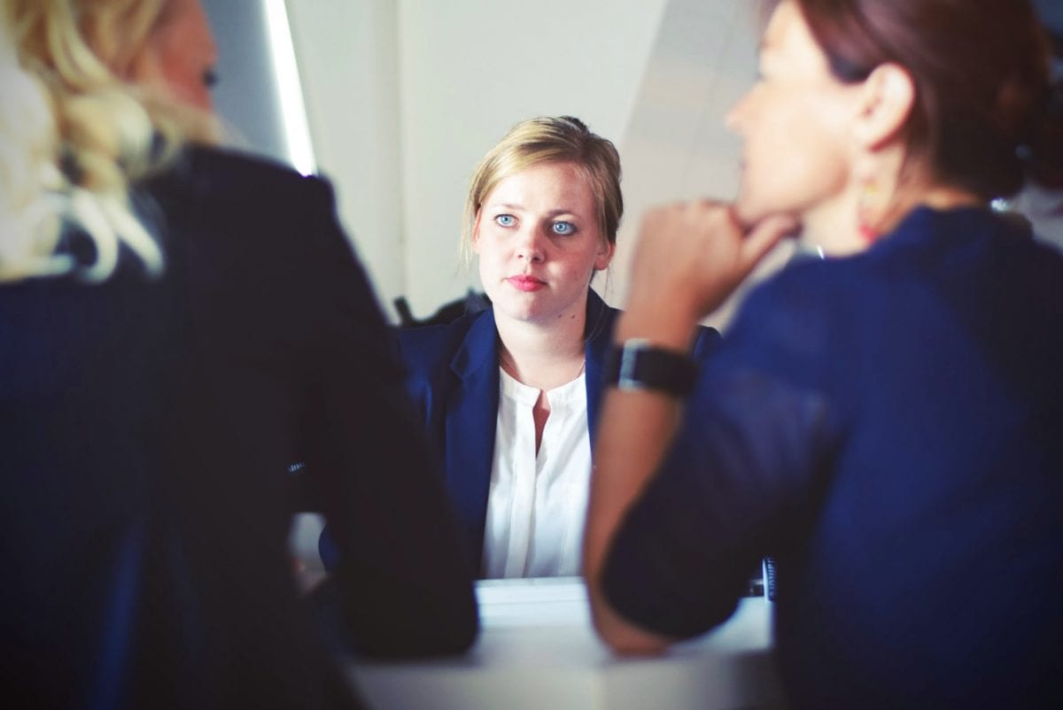 three women meeting in suits