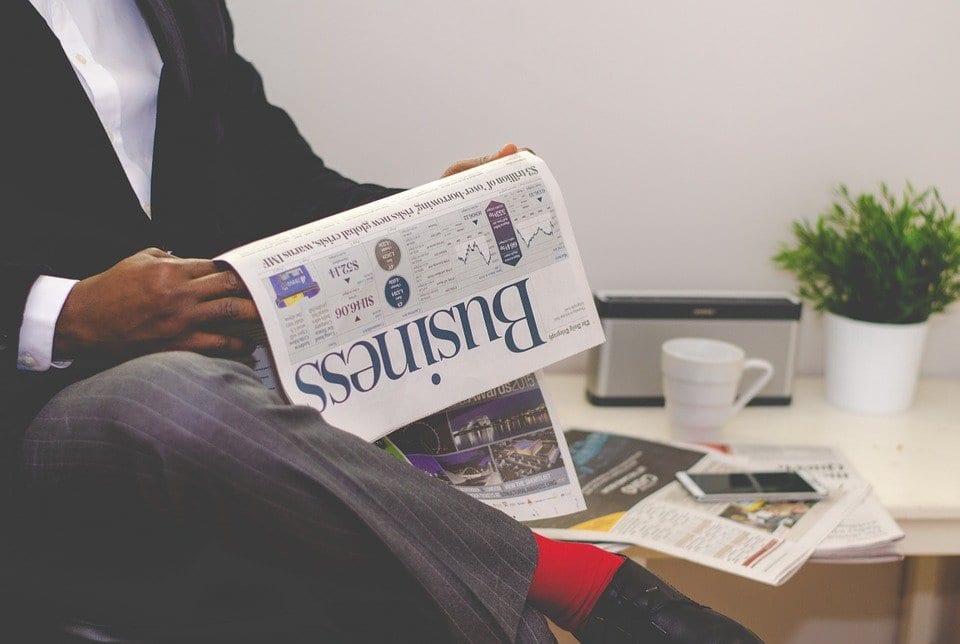 business man reading business paper